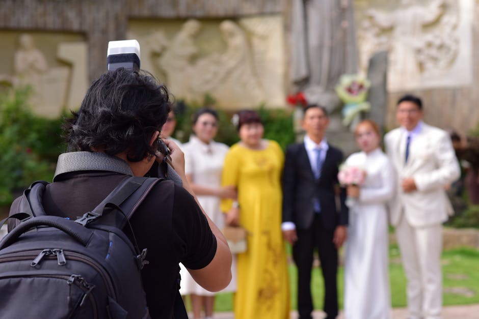 Professional wedding photographer capturing a candid moment at a venue