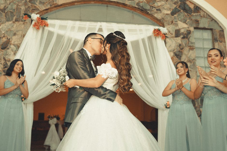 Newlywed couple sharing their first kiss at the wedding ceremony